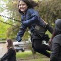 girl on swing set smiling